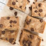 Squares of cookie dough protein fudge on baking paper