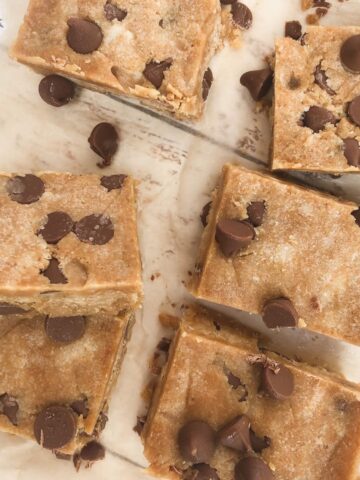 Squares of cookie dough protein fudge on baking paper